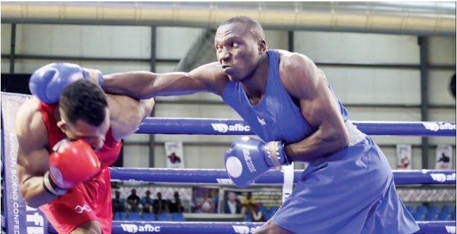 Kenya’s Robert Okaka (blue) in action against Moroccan Yassir Rigui
