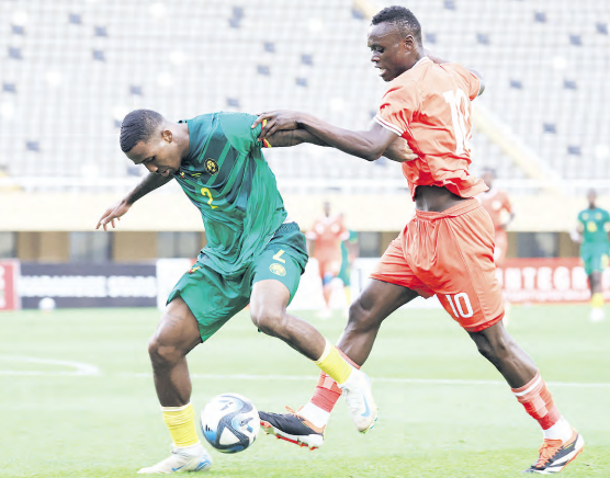Harambee Star's Timothy Ouma vies with Jackson Tchatchoua of Cameroon during a 2025 Cup of Nations qualifier