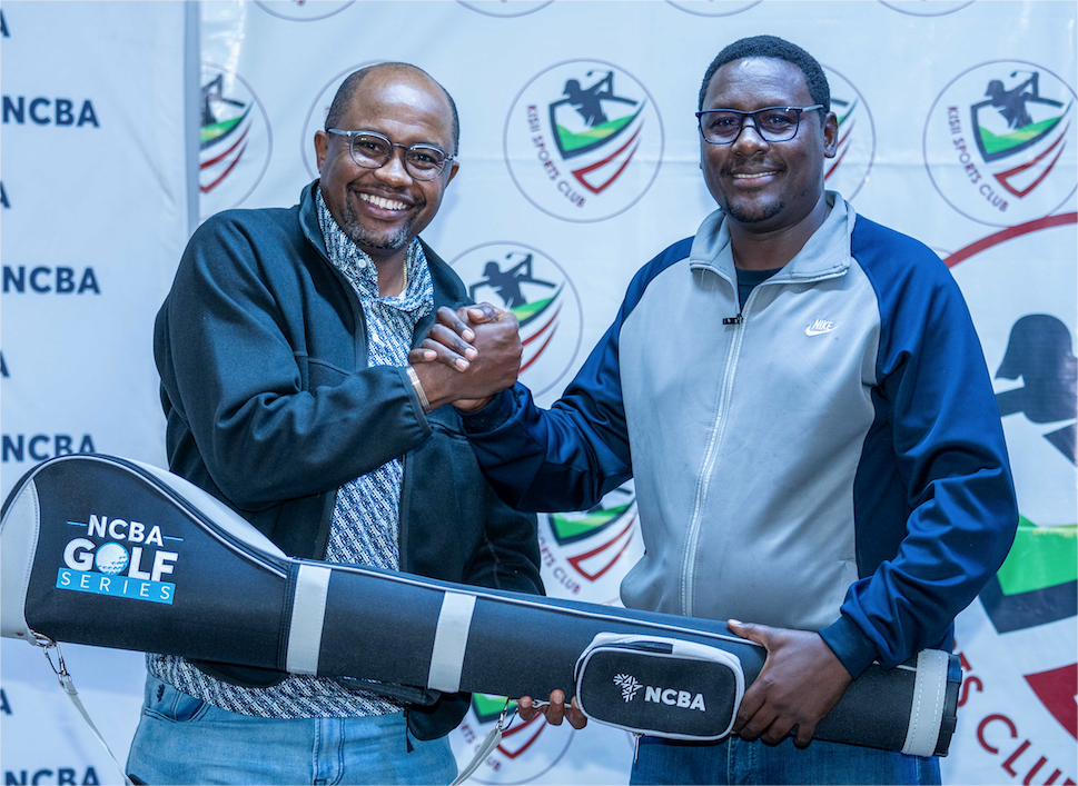 NCBA Group’s Tirus Mwithiga (L) awards the overall winner of the Kisii Monthly Mug, Elijah Simba