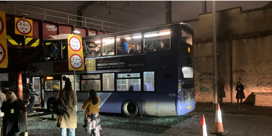 Eight injured after bus roof torn off in railway bridge crash