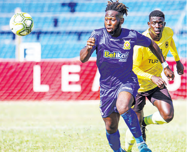 ABOVE: Timothy Oyanda of Police vies for the ball with Tusker’s Chrispine Erambo