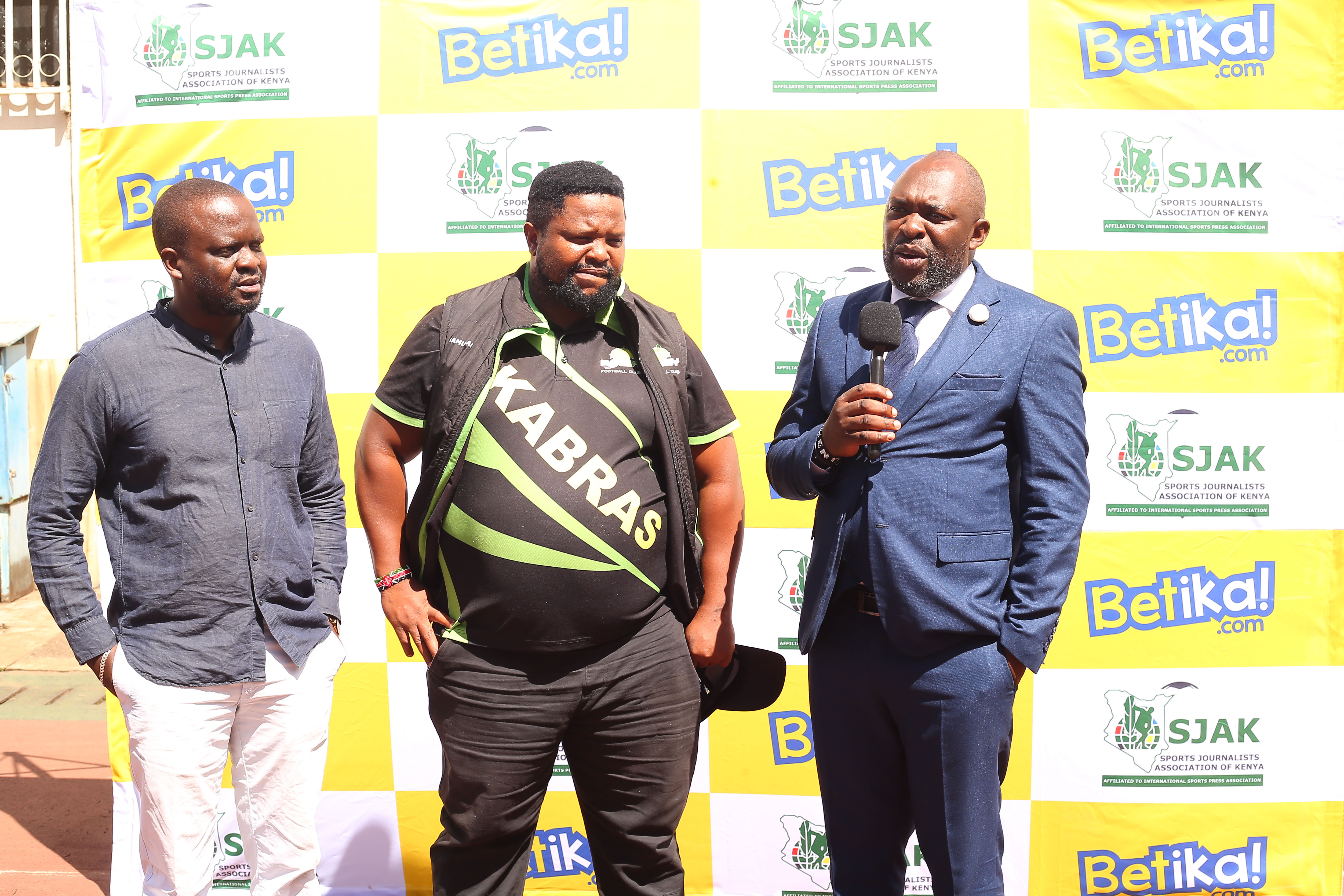 Kabrass sugar coach Carlos Kyatwa (C) poses with SJAK president James Waindi (L)  and  Betika's (Japheth)