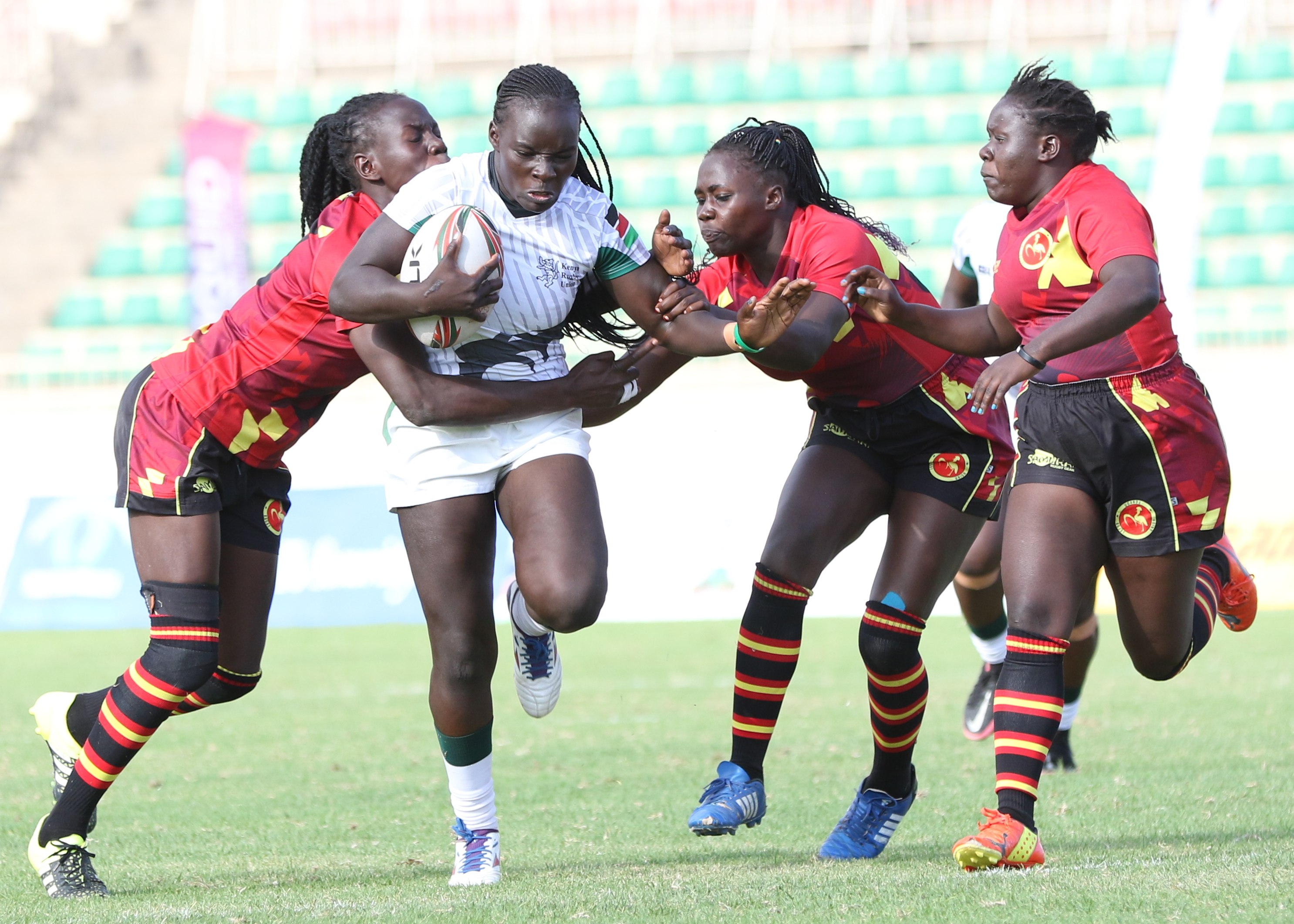Kenya Lionesses Grace Okulu shields the ball from Uganda Crane players/ FILE
