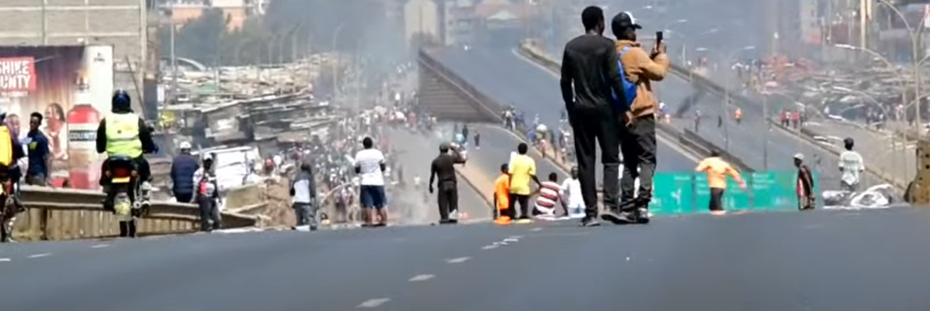 Protesters play football along Thika Super highway