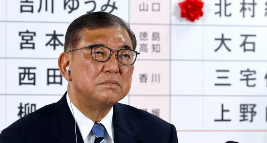 Japan's PM vows to stay on despite bruising exit poll