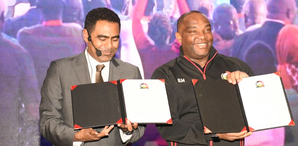 Hussein Mohammed (L), President of the Kenya Football Federation, and Benni McCarthy, Kenya national football team headcoach, display signed documents.