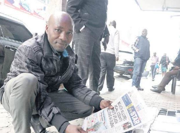 Star newspaper vendor Janalius Mutero at his workstation on Kaunda Street in Nairobi on July 8 /LEAH MUKANGAI