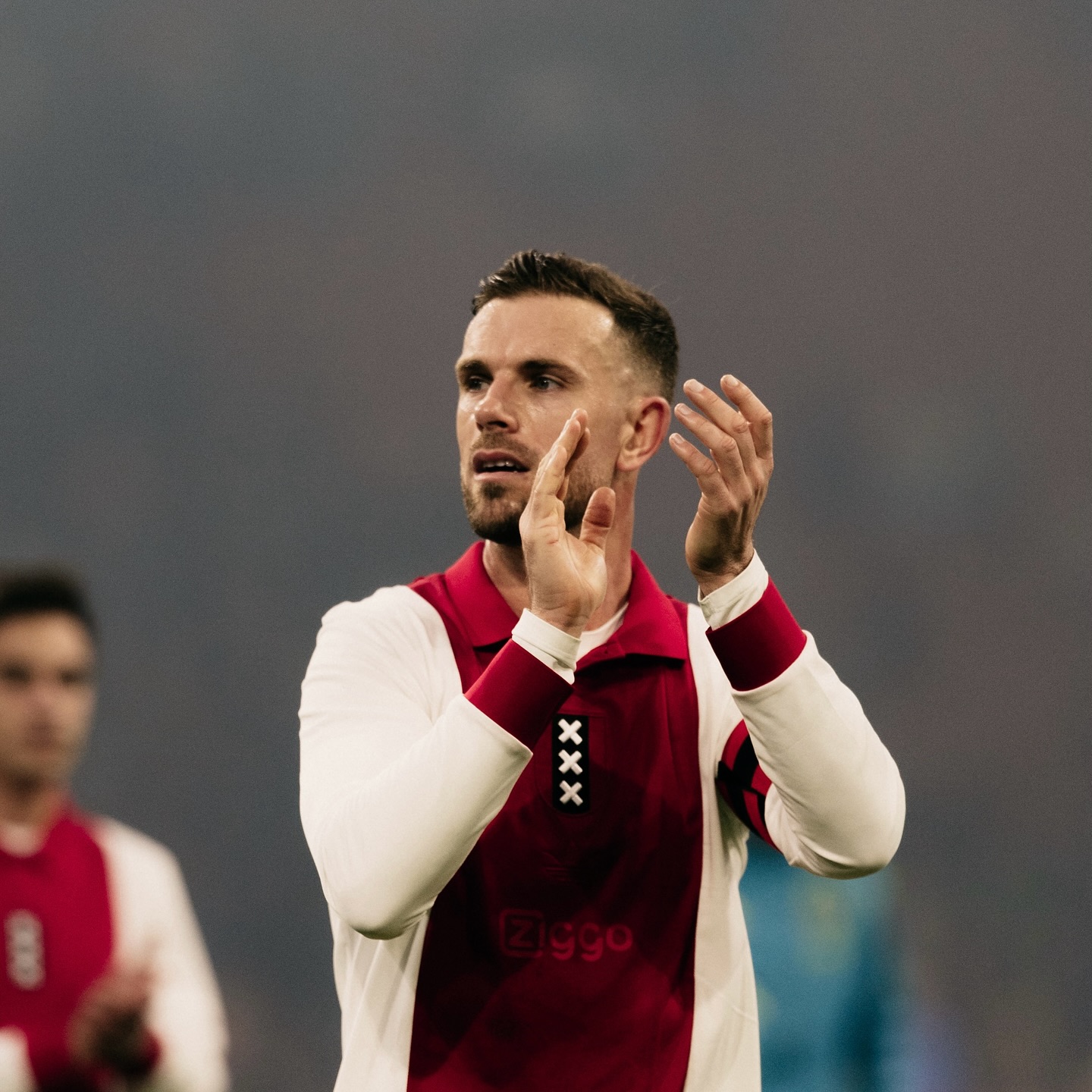 Jordan Henderson applauds the Ajax fans