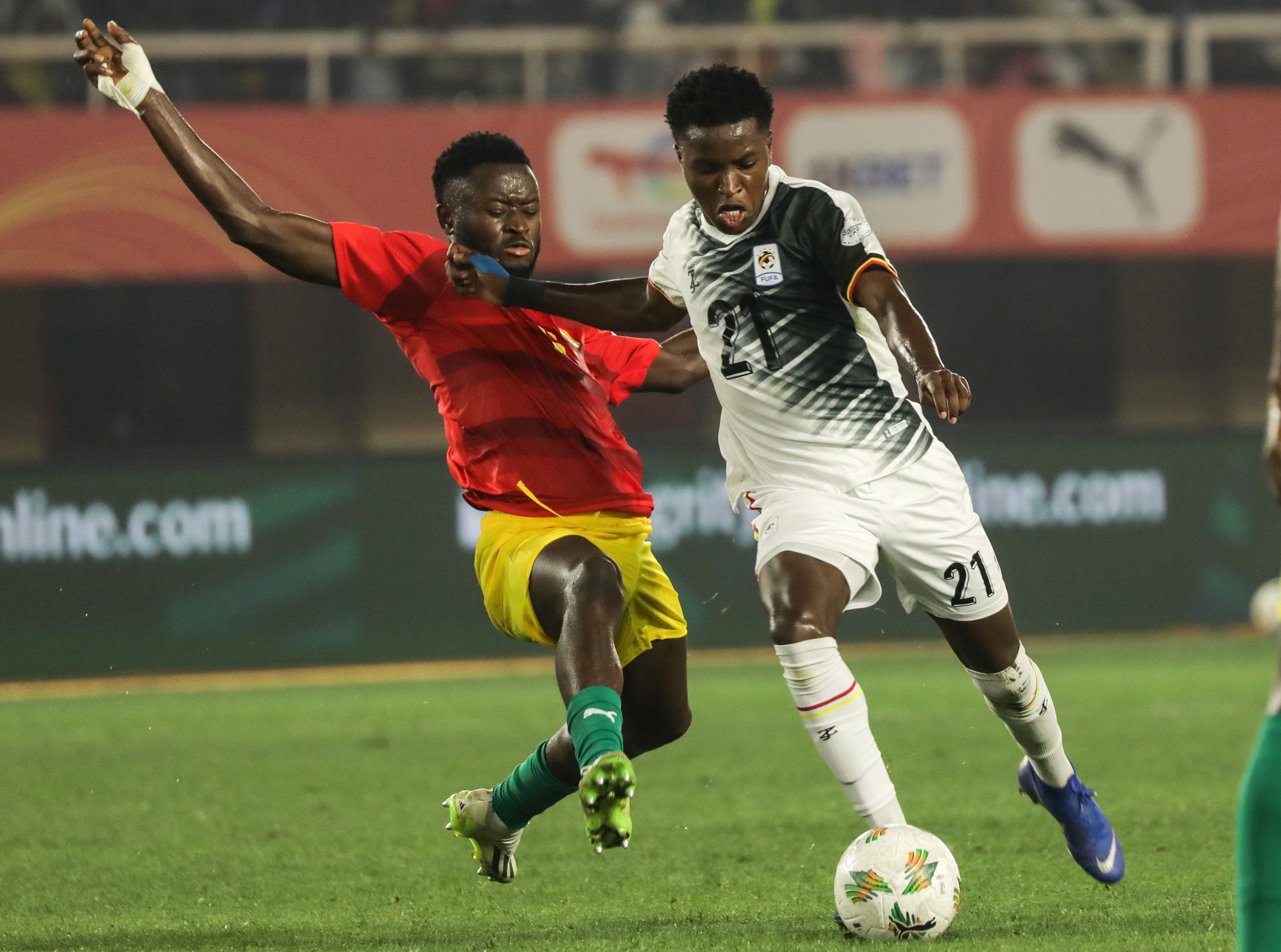Allan Okello (R) of Uganda vies with Ousmane Drame of Guinea during a CHAN 2024 Group 'C' match at Mandela National Stadium in Kampala, Uganda, on August 8