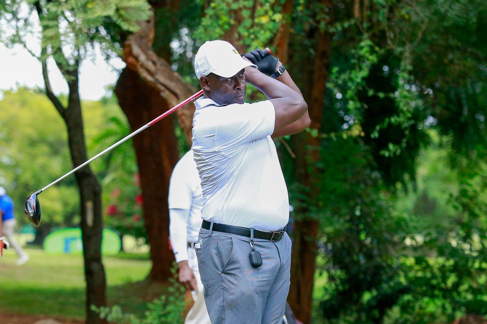 Golfer Anthony Mulisa follows his tee shot