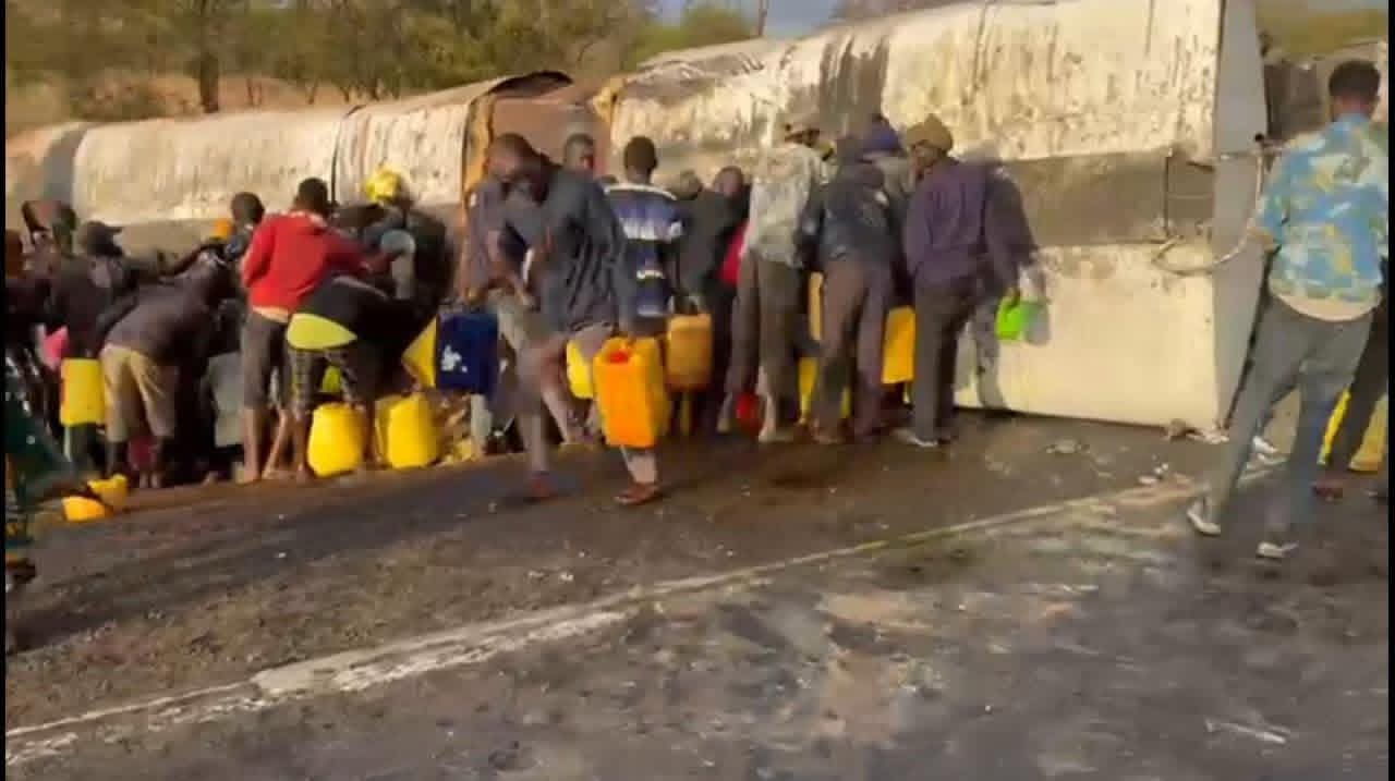 Police helpless as locals syphon fuel from overturned tanker