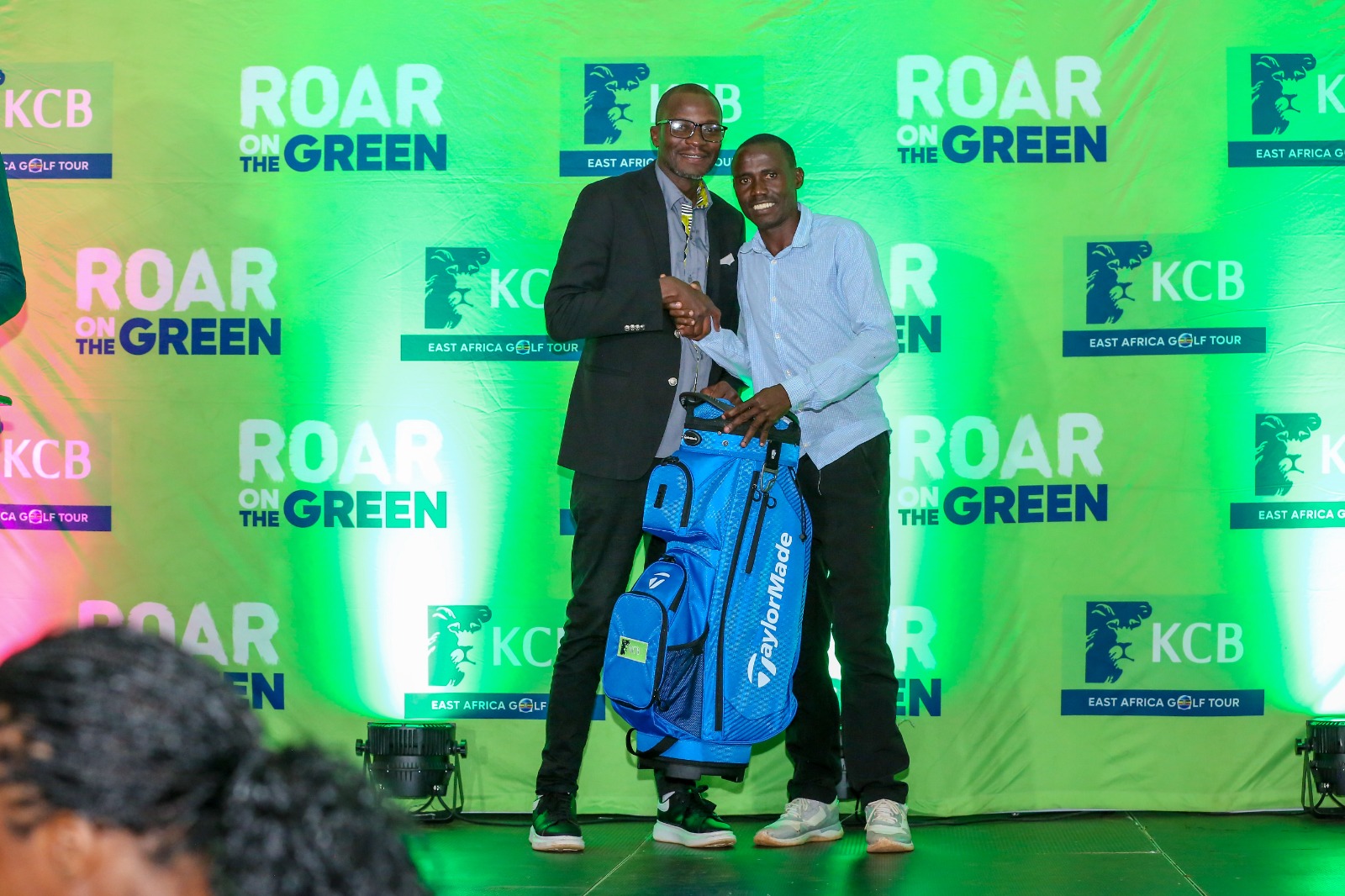 KCB Asset Management Director Victor Odendo awards overall winner Ben Okanya during the KCB East Africa Golf Tour in Kakamega