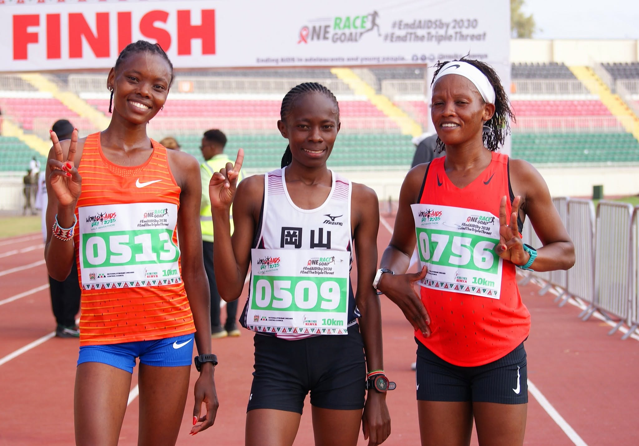 Regina Wambui (L), Diana Wanza and Monica Ngige (R) after completing the women's 10km race