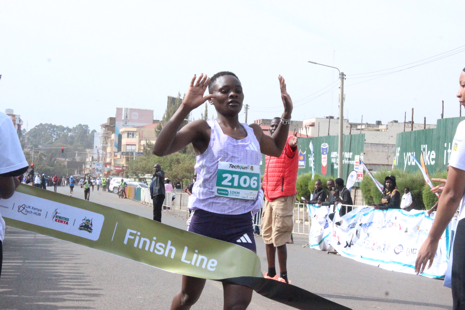 Maryam Lufti Njoki cuts the tape at the Eldohub Techrun 10K