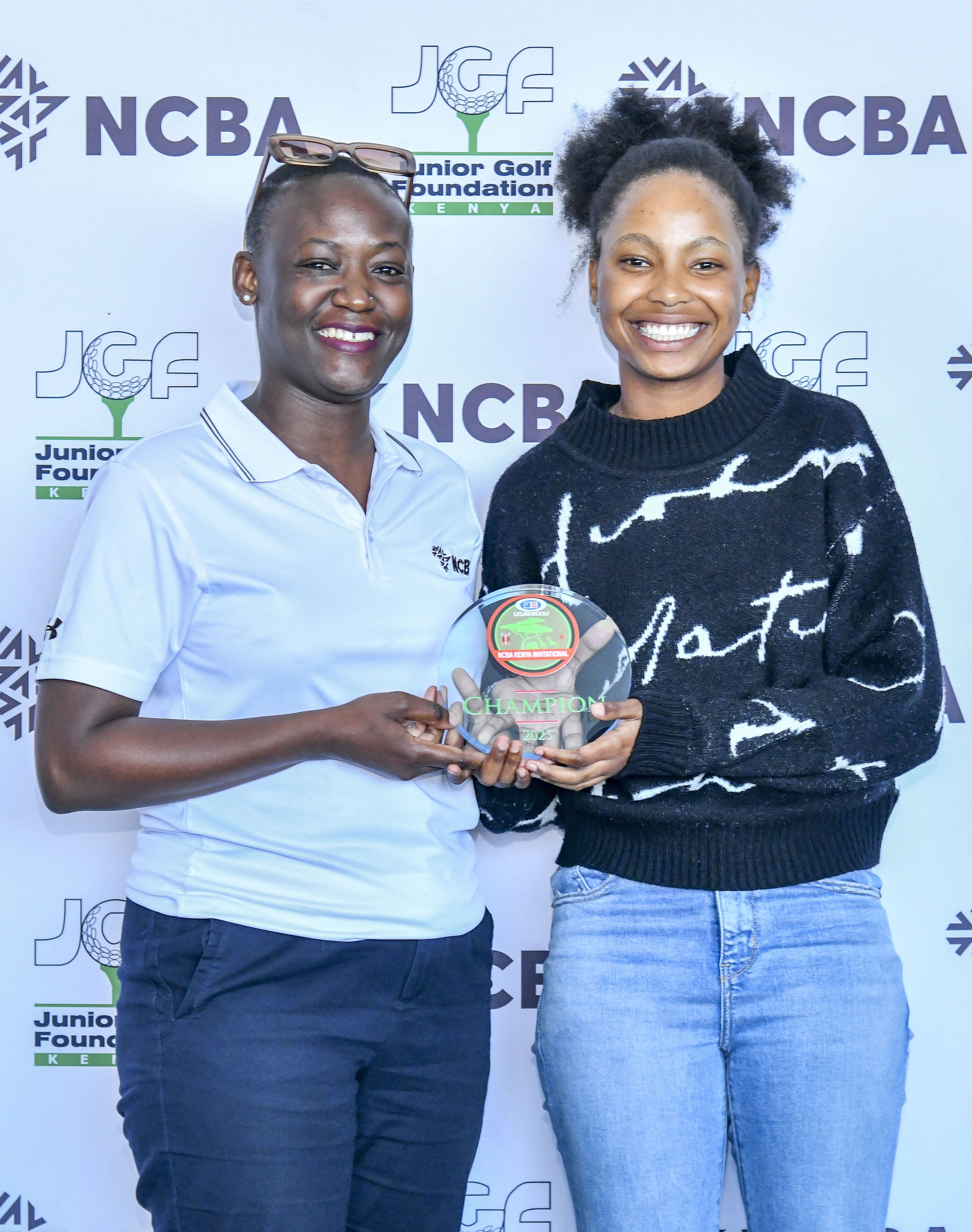 Bianca Ngecu (R), winner, 15-18 year old in the Girls division receives her trophy from NCBA Group Digital Marketing Manager Stephanie Adhiambo/HANDOUT