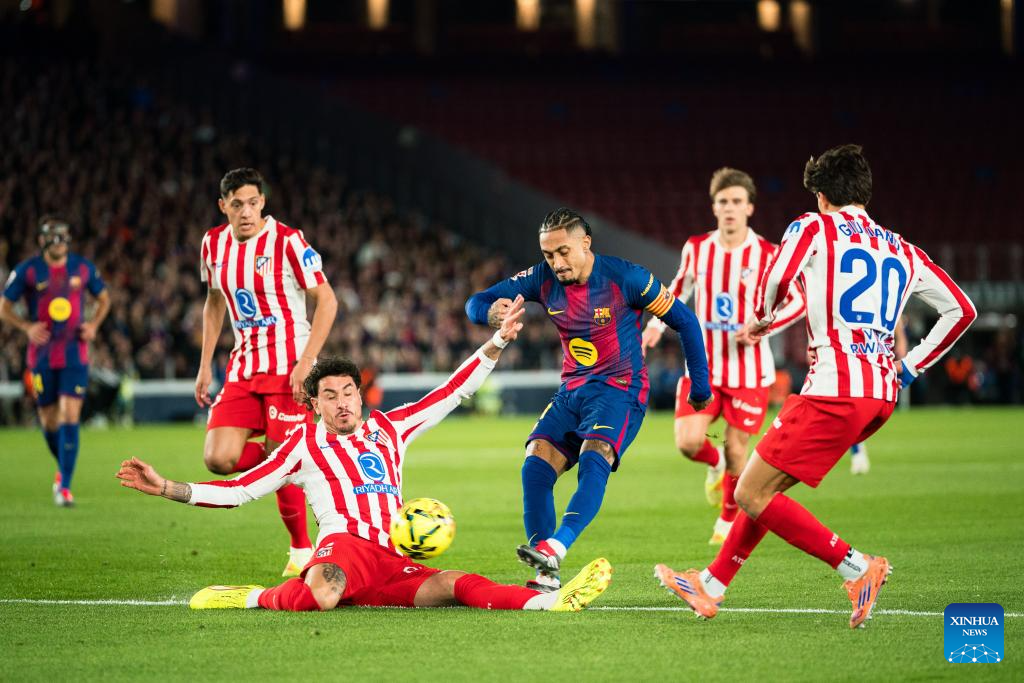 Raphinha (C) of Barcelona kicks the ball during the La Liga football match between FC Barcelona and Atletico de Madrid in Barcelona, Spain, on Dec. 3, 2025. --