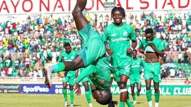 Gor Mahia forward Shariff Musa executes a back flip after netting a goal in a previous match as teammate Paul Ochuoga looks on/GOR