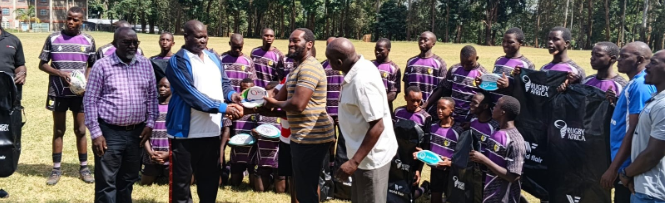 St Mary's School Yala principal VO Makanda (L) receives rugby from members of the Yala Old Boys Association (YOBA)/ANGWENYI GICHANA