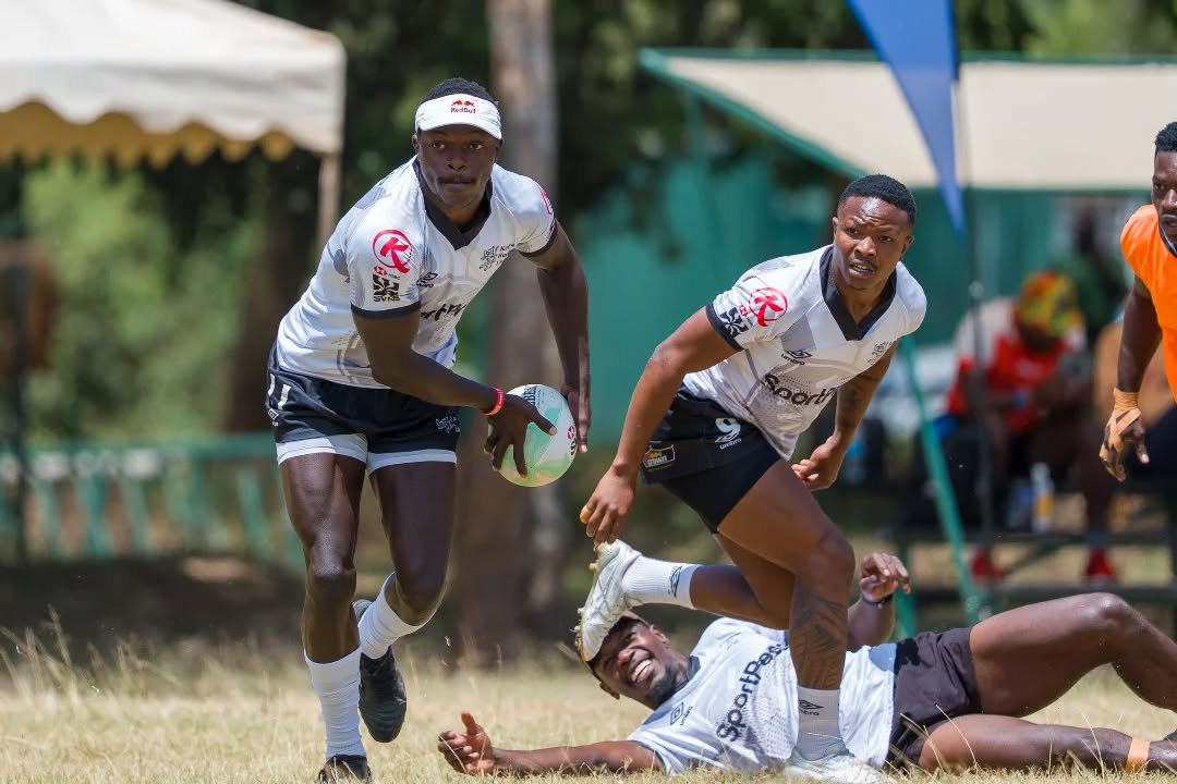 Kenya seven star winger Patrick Odongo looks to pass the ball as Samuel Asati and Vincent Onyala look on