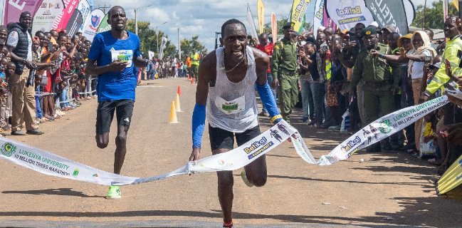 Elijah Mbaire cuts the tape at the Lukenya Marathon/ HANDOUT