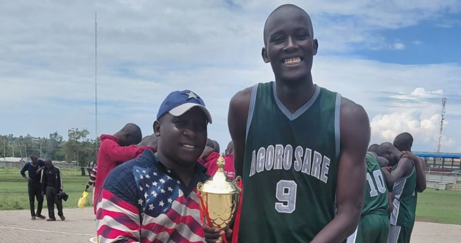 Agoro Sare coach Paul Odock with Seth Omondi after they retained the county title for the ninth consecutive year/ANGWENYI GICHANA