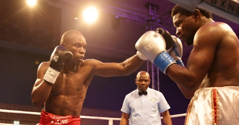 Kenya's John Juma (left) trades jabs with Tanzania's Charles Chalala/HANDOUT