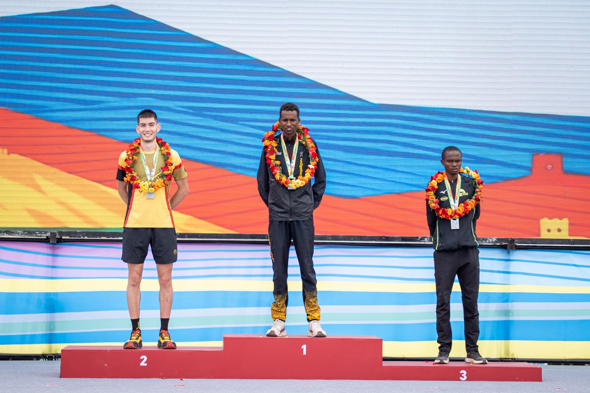 Michael Saoli (C) poses for a photo with Paul Machoka (R) and Isaaco Costa on Sunday