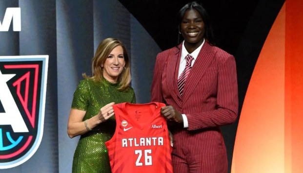 Madina Okot holding up an Atlanta Dream jersey with WNBA commissioner Cathy Engelbert/HANDOUT