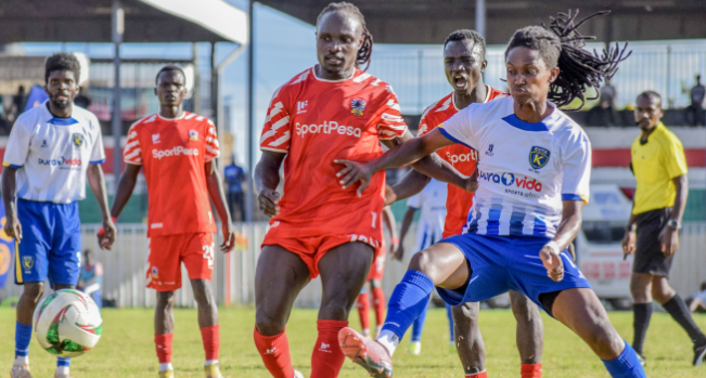 Kuta collection FC striker Bryan Tobiko (L) battles for the ball with Shabana midfielder Bronson Nsubuga/ HANDOUT