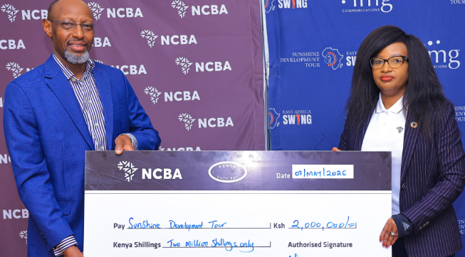 Nelly Wainaina, NCBA Group Director for Marketing, Communication and Citizenship, presents the Bank's sponsorship for the Sunshine Development Tour to the Tour's Managing Director, David Ndung'u/HANDOUT