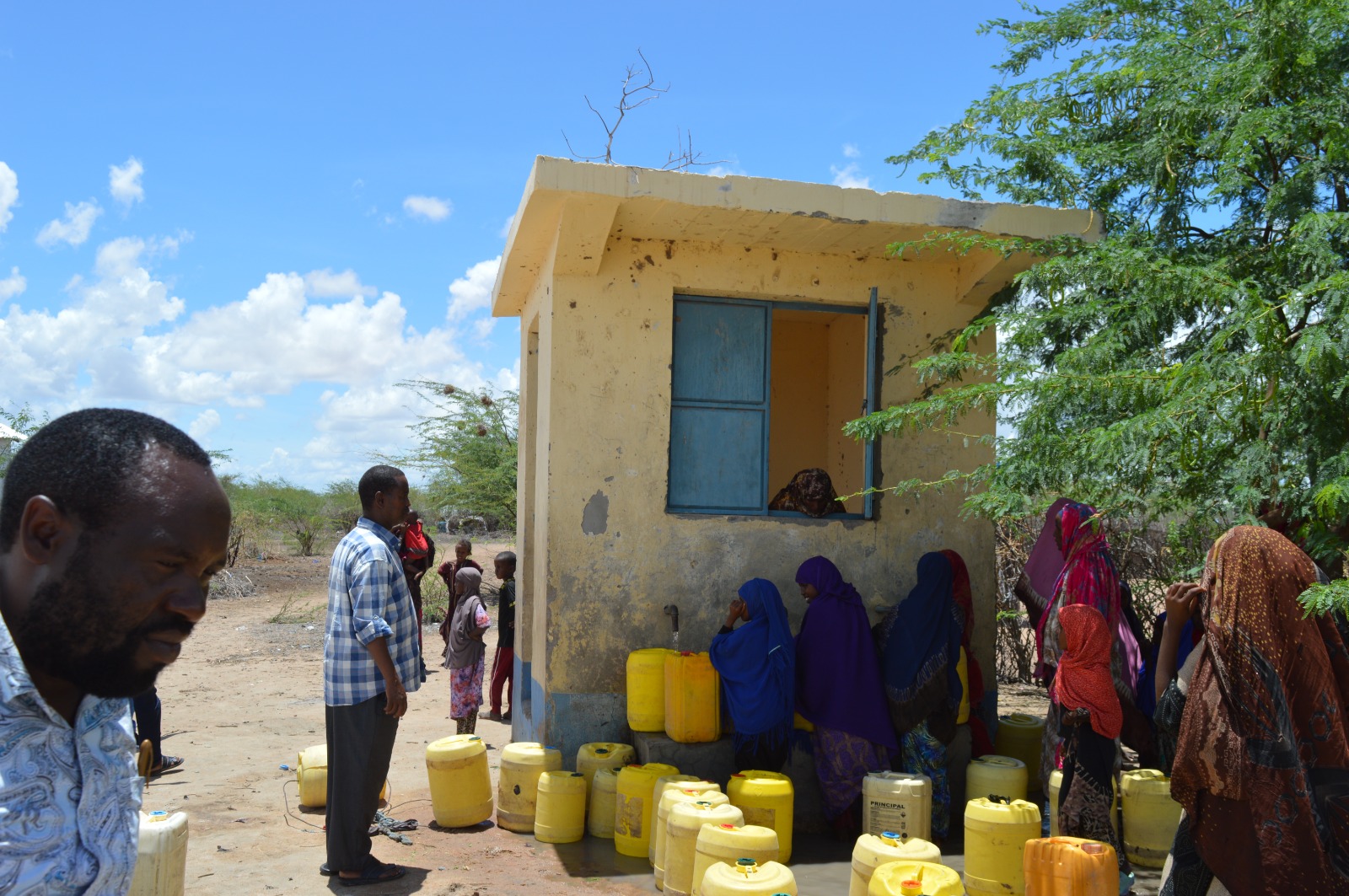 Residents of Labisigale,  fetching water from a kiosk.