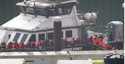 Separately, a group of people thought to be migrants are brought in to Dover by UK Border Security forces on Sunday./SCREENGRAB