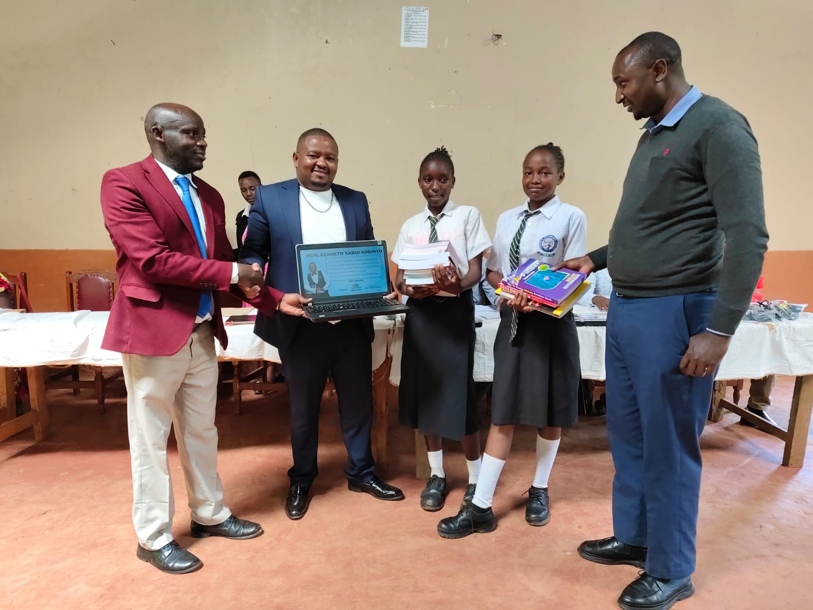 Kabui Kihunyo foundation patron Kenneth Kabui (second left) handing over computers to Karung'e secondary school's fraternity led by principal Richard Wainaina on May 5, 2026/ ALICE WAITHERA
