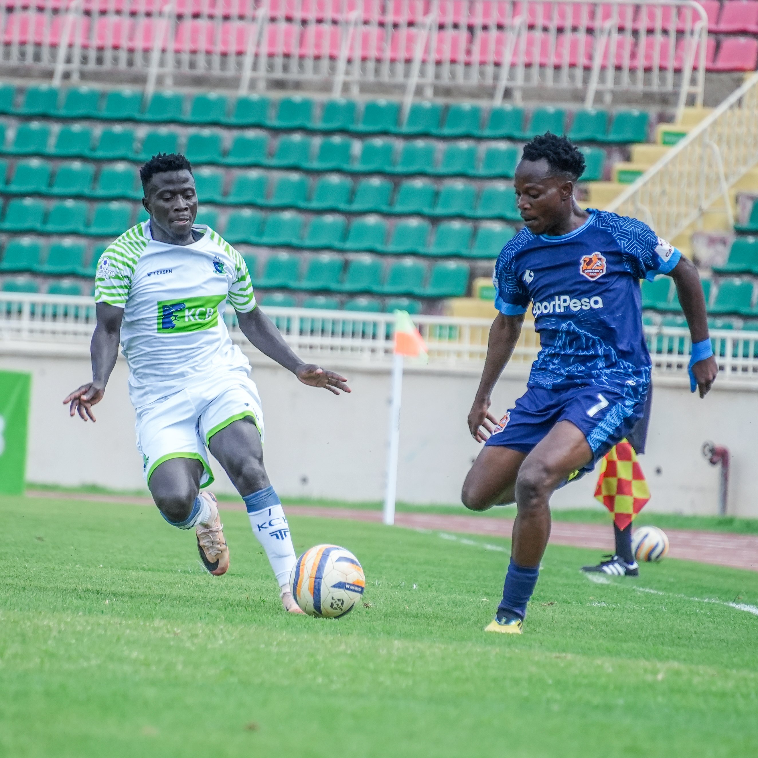 KCB's Boniface Omondi (L) vies for the ball against Murang'a Seal's Price Musebe