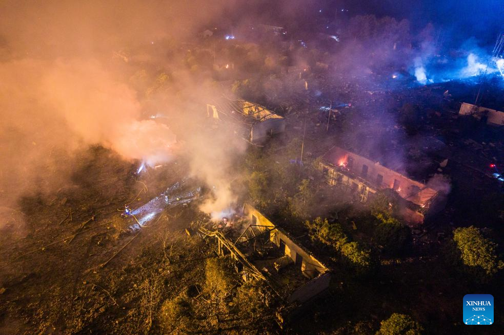 This aerial drone photo taken in the early hours of May 5, 2026 shows rescuers working on site after an explosion at a fireworks plant in Guandu Town of Liuyang, central China's Hunan Province. The fireworks plant explosion on Monday in central China's Hunan Province has left 21 people dead and 61 others injured, authorities said Tuesday. The explosion occurred at around 4:43 p.m. Monday at the plant of Huasheng fireworks manufacturing and display company in Liuyang, a county-level city under Changsha, capital city of Hunan. More than 480 rescuers in five teams have been mobilized for the rescue, with three rescue robots deployed. (Xinhua/Chen Sihan)