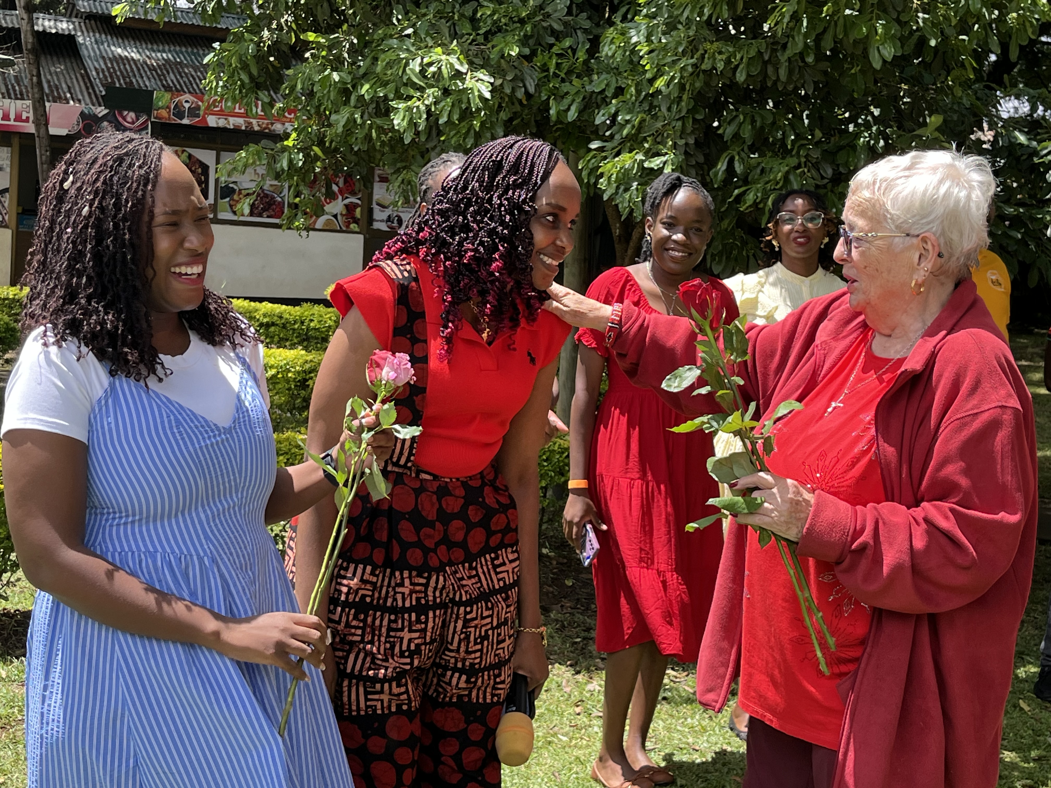 Elizabeth Scott receiving flowers from some of her former learners at Kipkeino school in Eldoret
