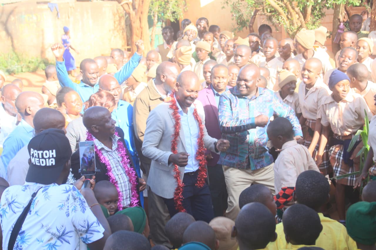 Mwingi West MP Charles Nguna joins a school dancing troupe in a jig at Mbondoni Primary School in his constituency during the handing over of an administration block on Tuesday.