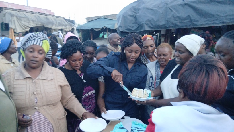 Ndaisi Kipanga (C) joins women in cutting a cake to mark the Mothers Day at Athi River Open air market in Machakos County on May 10, 2026.