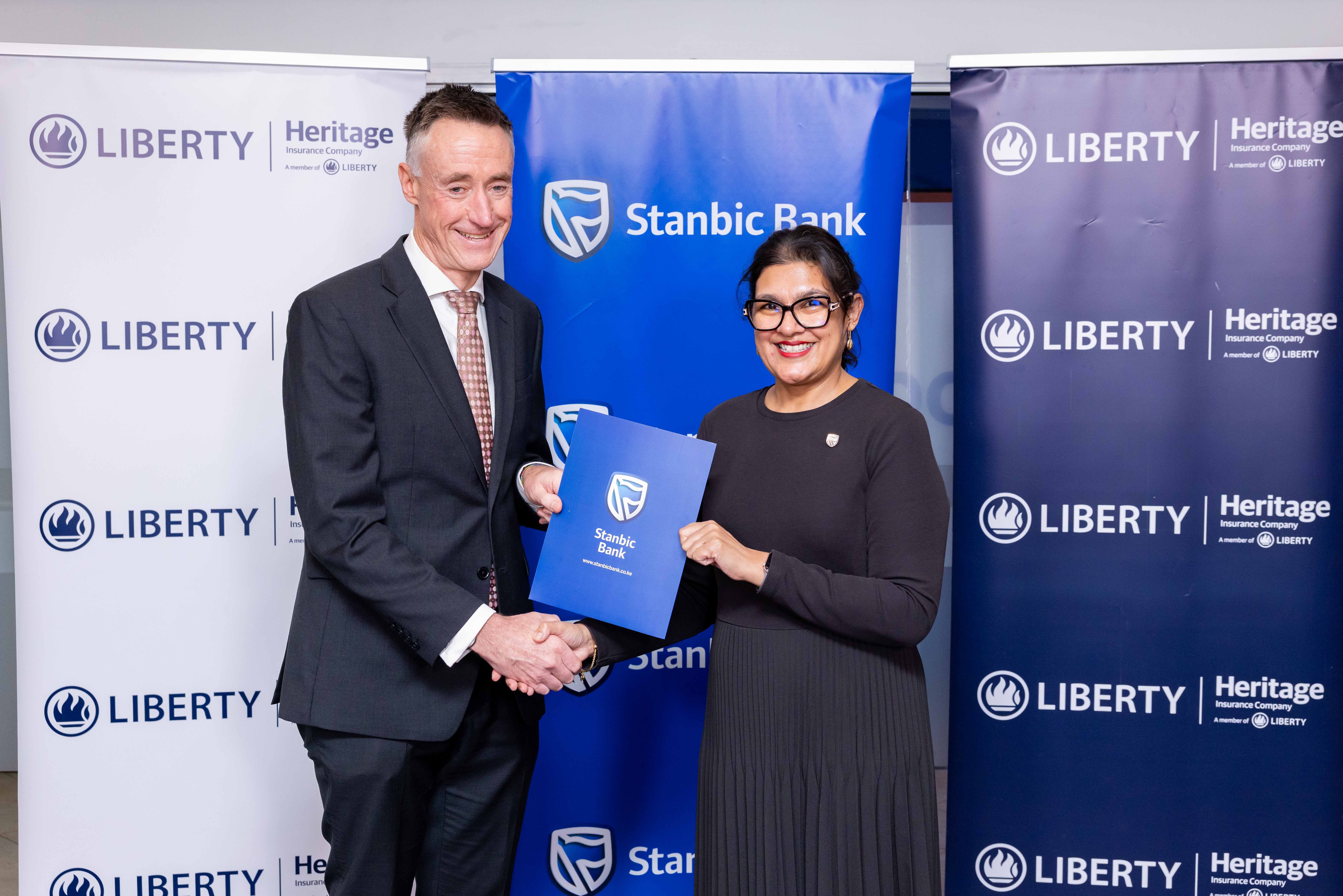 : Kieran Godden, Group CEO, Liberty Kenya Holdings Plc, and Anjali Harkoo, Head of Insurance and Asset Management at Stanbic Bank Kenya, during the signing of a Vehicle and Asset Financing partnership between Stanbic Bank and Liberty Kenya. The partnership introduces enhanced insurance cover for commercial vehicle owners and fleet operators, offering broader goods-in-transit protection, personal accident cover, regional coverage and excess protector benefits to support SME growth and business continuity in Kenya’s transport and logistics sector.
