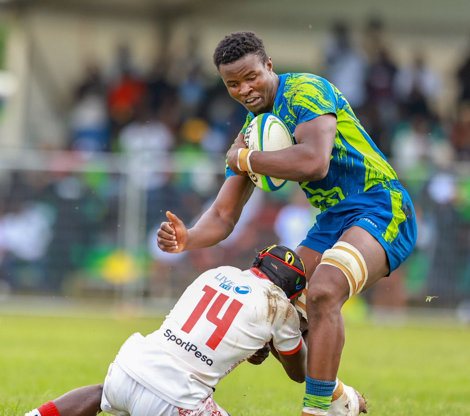 KCB flanker Elvis Olukusi fends off Daniel Okito during the Kenya cup semifinal