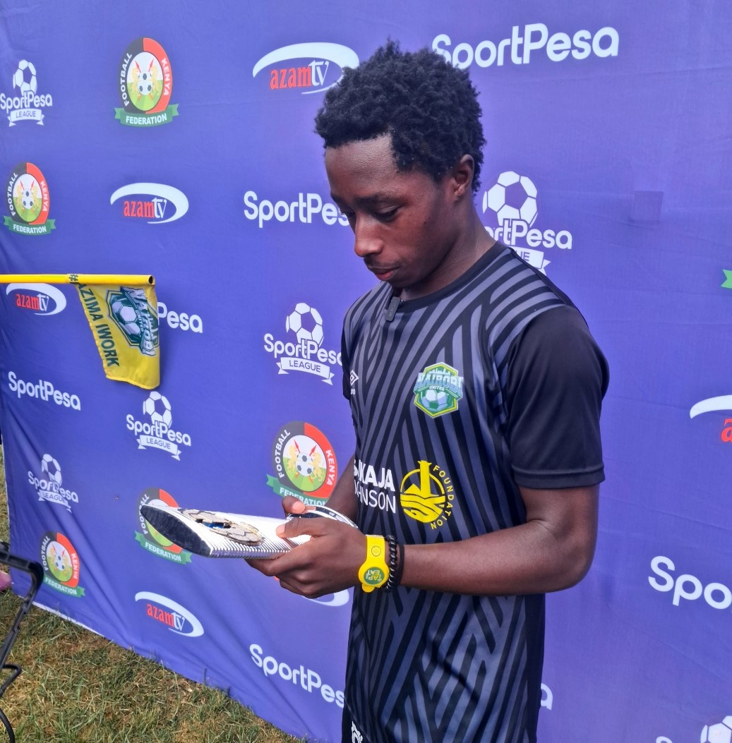 Kevin Wangaya admires the trophy after winning the SportPesa player of the month award for April