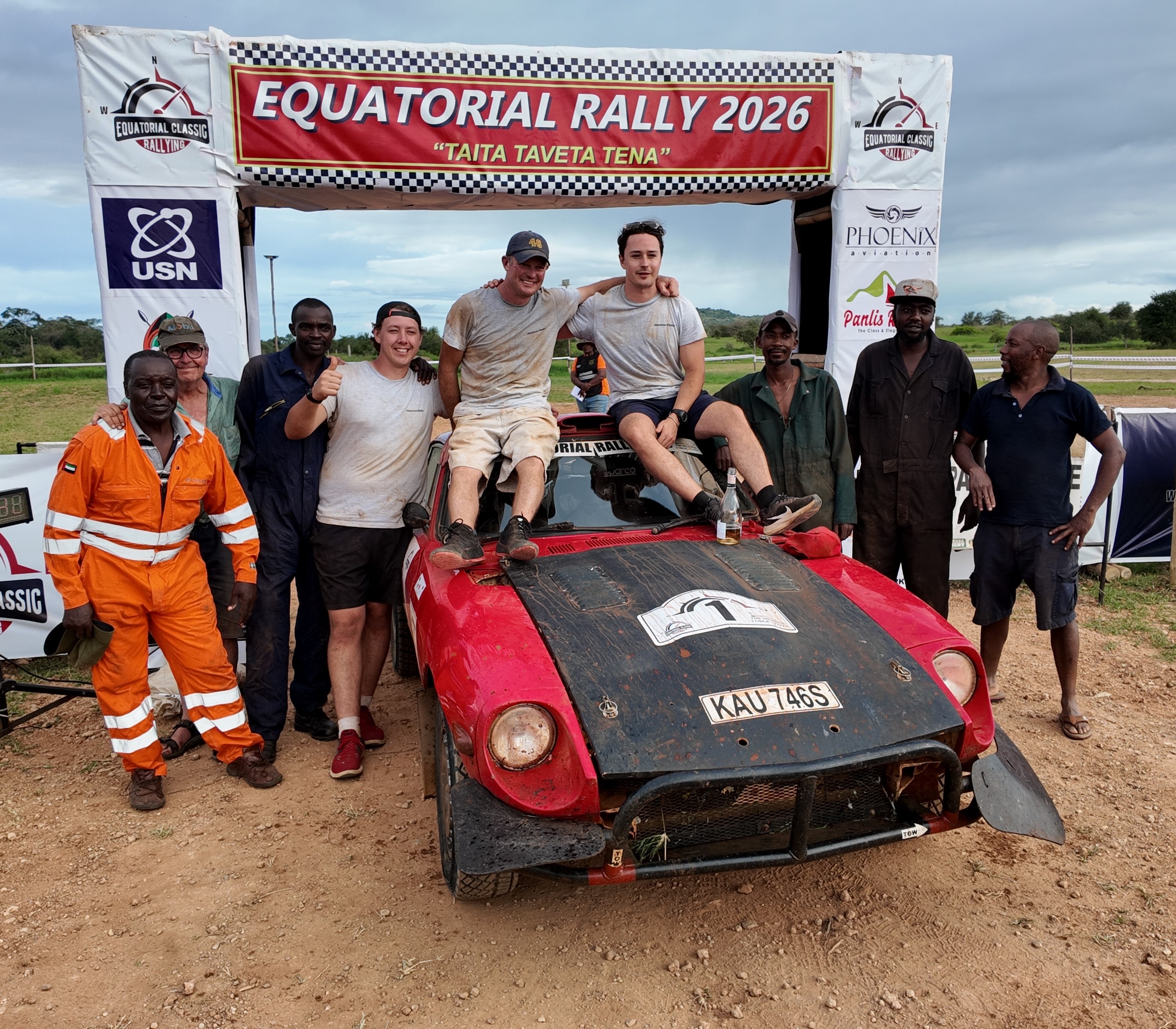 Piers Daykin and navigator Lloyd Destro pose for a photo with their team after winning the rally
