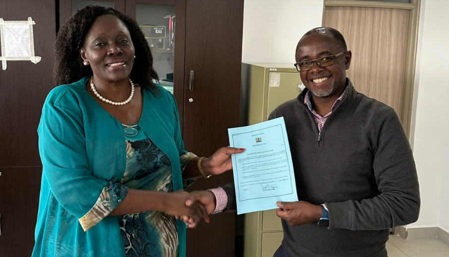 Motorsports Kenya Federation Interim General Secretary Eric Bengi receives the Certificate of Registration from Sports Registrar Rose Wasike in Nairobi on Tuesday/ HANDOUT