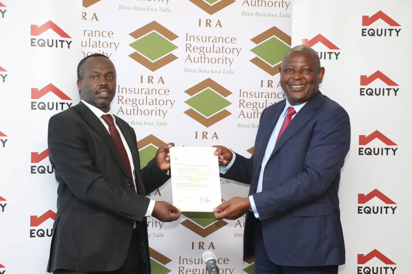 Insurance Regulatory Authority (IRA) CEO, Godfrey Kiptum with Equity Bank Group MD , James Mwangi when he received licence for Equity Life Assurance (Kenya)