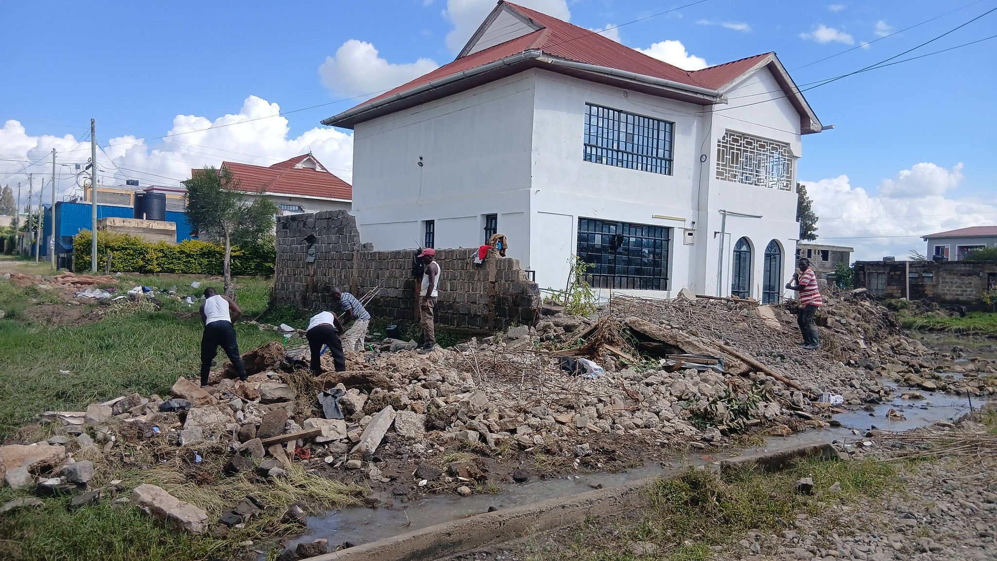 Men scangaving for steel metal after a house's perimeter wall was pulled down during demolitions in Githunguri, Machakos County on May 6, 2026.