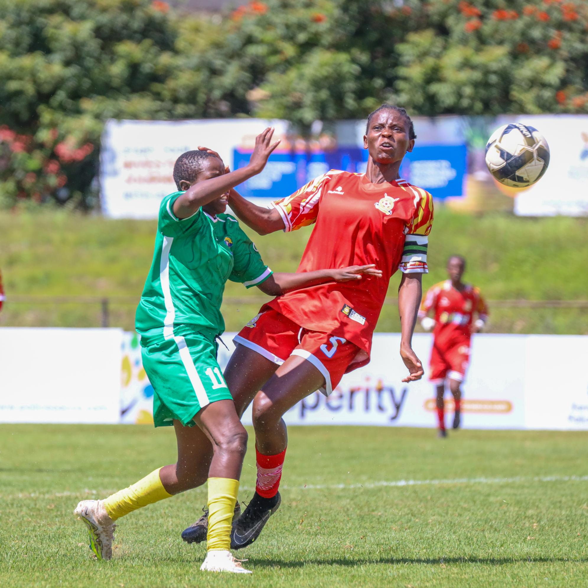 Kenya POlice striker Elizabeth Ochaka shields the ball from Vihiga Queens' during their match