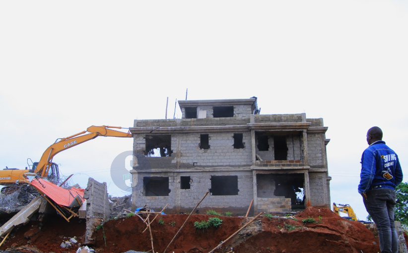 A man watches as a bulldozer demolishes a palatial home in Marurui on a 300-acre disputed land, May 5, 2026. /EZEKIEL AMING'A