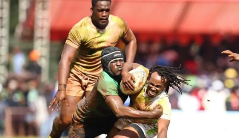 KCB's  Brian Wahinya with ball is tackled by Bryceson Adaka of Kabras as Sheldon Kahi looks on during the Kenya Cup final held in Kakamega/HANDOUT