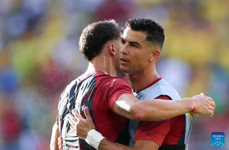 Cristiano Ronaldo (R) of Portugal hugs teammate during the warm-up before the group K match between Colombia and Portugal at the 2026 FIFA World Cup at Miami Stadium, Miami, the United States, June 27, 2026. (Xinhua/Zhang Chen)