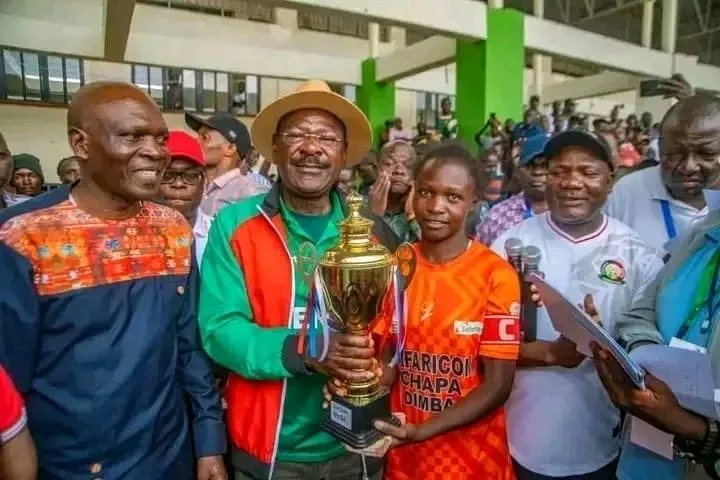 Archbishop Njenga Girls captain Hilda Natecho receives the Western region trophy from National Assembly Speaker Moses Wetangula/HANDOUT